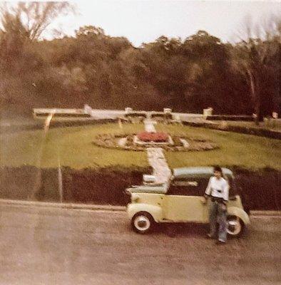 Summer, 1982: the entrance drive is still open to Highway A.  Rita Rinelli stands next to a 1942 Crosley.