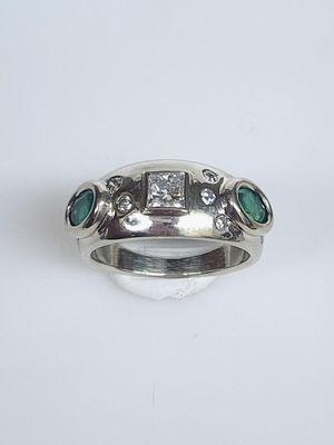 Custom design emerald and diamond ring in 14k white gold.