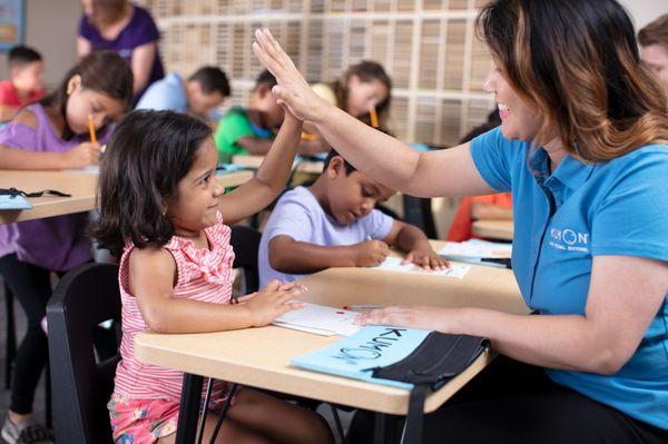 Preschool student receiving encouragement.