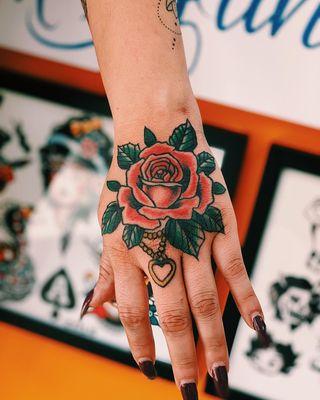 Rose hand tattoo by Ryan Bogart