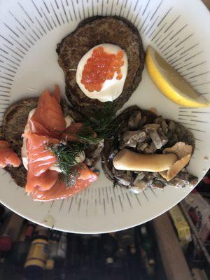 Red caviar , mushrooms, and lox blinis