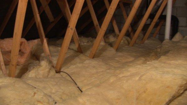 Batt roll fiberglass roof insulation instalation in Sacramento attic.