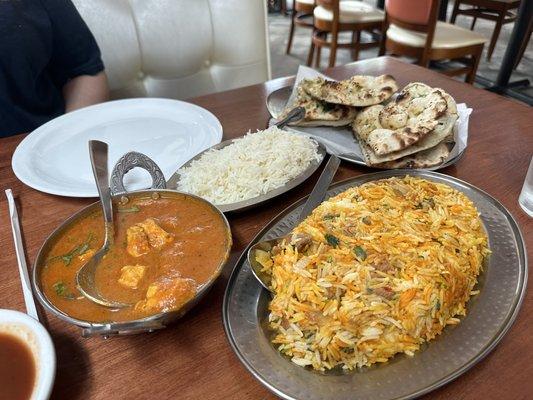 LAMB BIRYANI (GF) - on the right Chicken Curry with white rice - on the right  Garlic Naan - in the back