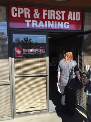 Standing in line and taking care of paperwork before the class begins.