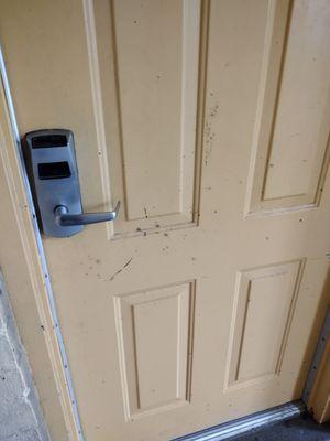 Destroyed hotel room door.