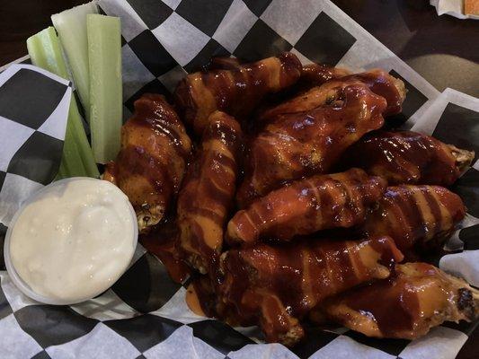 Hot barbecue buffalo wings with blue cheese dressing and celery.