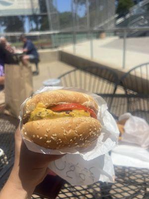 Cheeseburgers with added tomato and onion