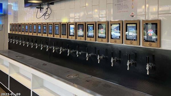 Line of self-serve beer taps