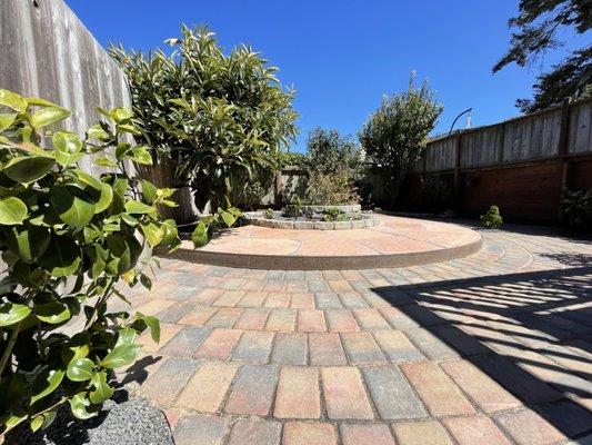 Two level concentric patio built around an existing kidney-shaped planter made this yard more functional and beautiful.