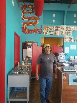 Fidel, the owner posing for me at his colorful and artistic market stop