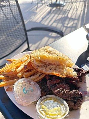 Steak dinner with fries and garlic bread