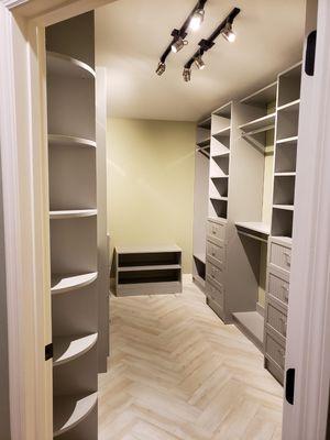 Walk-in Closet in Light Gray with ample drawers and corner shelving at the enterance.