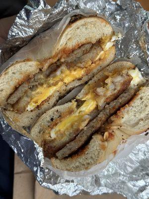 Sausage egg and cheese with a hashbrown on a toasted everything bagel