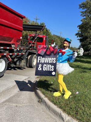 Embarrassing Donald Duck Costume waving to traffic for Romulus Flowers in Romulus MI