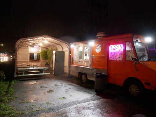 Carport with tables next to the truck so you can eat there even if it's raining!