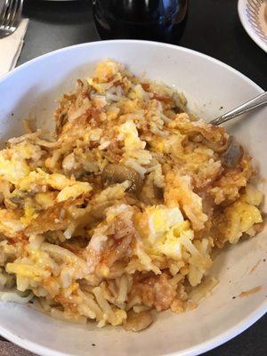 Hash brown bowl without meat, capped & scattered with ketchup & grits added