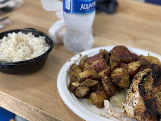 Quarter chicken with rice and seasoned potatoes