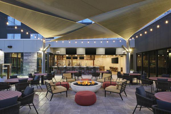 Outdoor patio with fire pit and large screen TV's