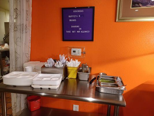 Plates, bowls, cutlery, and some chutneys