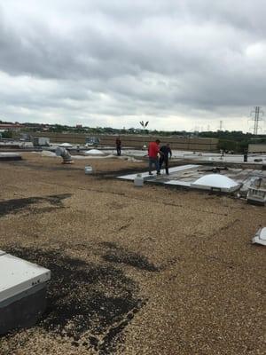 Our workers are repairing some leaks on this asphalt roof in Carrollton, Texas.