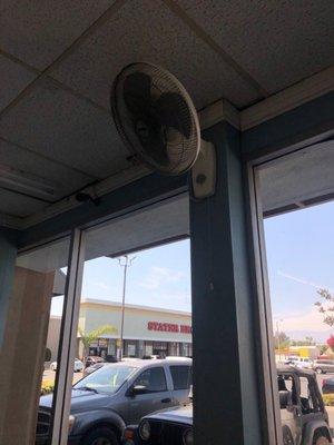 Tiny fans blowing hot air around the laundromat & there is no A/C