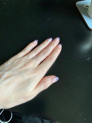 Photo of a white woman's hand with sparkly purple French Tip nails