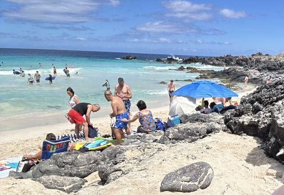 People of all ages. You can see the shallow beach.