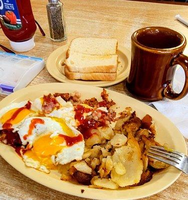 03/25/23 Corned beef hash eggs sunny side up on top Just a splash of ketchup home fries sourdough toast and coffee yummers!!