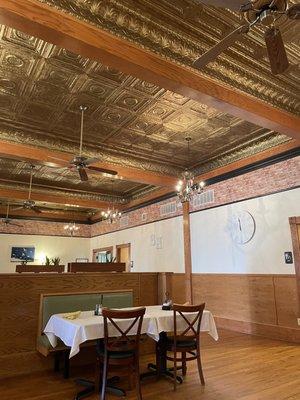 Interior dining area with high ceilings of fans and chandeliers.