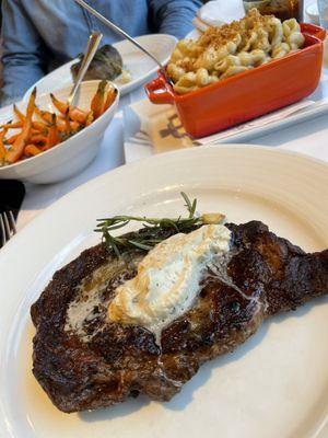 32 oz. Porterhouse with White Truffle Butter and Roasted Baby Carrots (background)