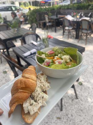 half chicken salad croissant and salad