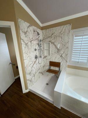 Remodeled the shower portion of a cali-combo. This one is still waiting on glass. Calcutta Marble walls, seat, chrome fixtures.