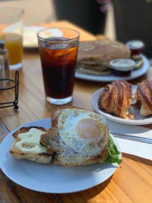 BLT biscuit sandwich with an egg, crusher croissant, sourdough pancakes, cold press, OJ