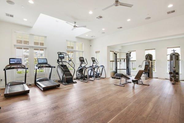 Spacious gym filled with gym equipment on hardwood floors at Lantower Edgewater