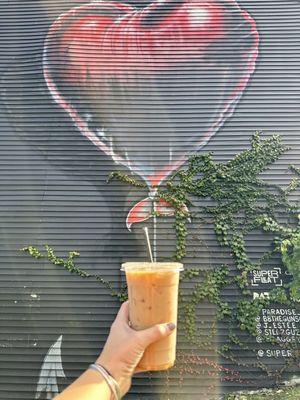 Iced coffee and local wall art