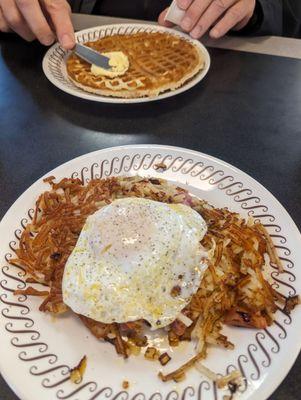 Hash browns with onions tomatoes ham and egg. My husband's waffle