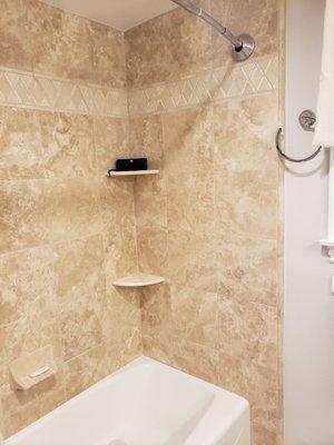 Travertine tile including quarter round for corners.