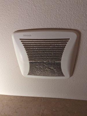 Men's restroom vent caked with dust