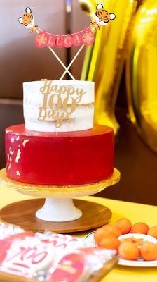 Cake with red fondant and gold flakes and naked cake