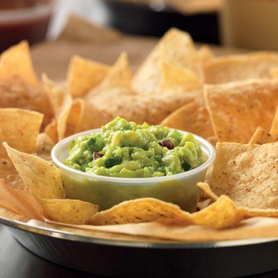 Hand-smashed-in-house-daily guacamole is best served with freshly fried in-house tortilla chips.