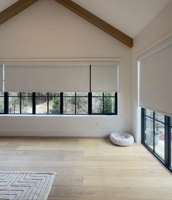 after photo of large windows covered by roller shades