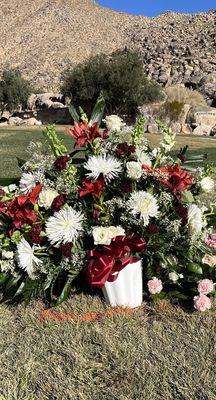 Arrangement ordered for a funeral service. This is what you get for $100.00. At least a third of the flowers were wilting and/or dead.