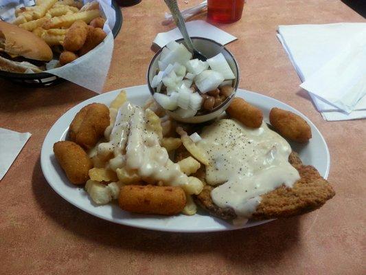 Country fried steak and fries with a side of pinto beans the perfect lunch