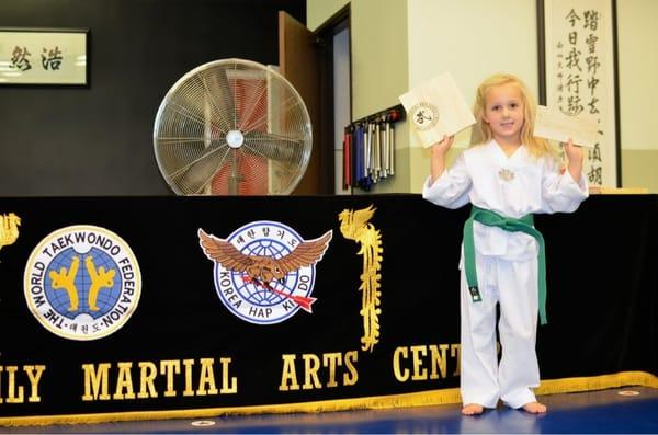 My 5 year old daughter broke her first REAL wooden board for her green belt test. I was impressed!!