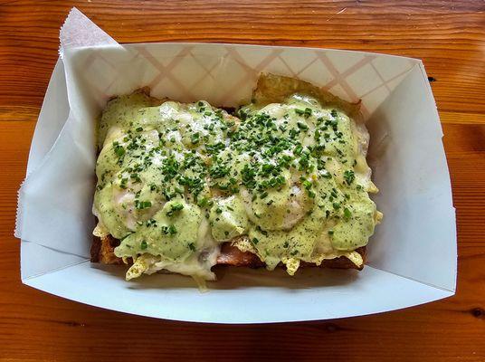 International; waffle w/ Canadian bacon, swiss cheese, pesto buttermilk ranch, chives, topped w/ 2 eggs.