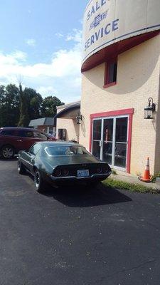 Camaro and front of building