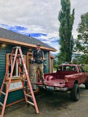 Installing custom wood gutters.