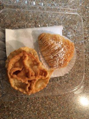 Sfogliatelle crispy shell on outside stuffed with sweet ricotta cheese and candy fruit pieces inside and fried dough ribbons.