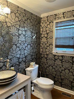 Dramatic new wallpaper and fabulous new vanity with interesting vessel sink.