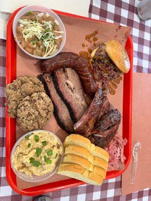 Chopped brisket sandwich, pork ribs, moist brisket, sausage, cheesy taters, pinto beans, and cookies